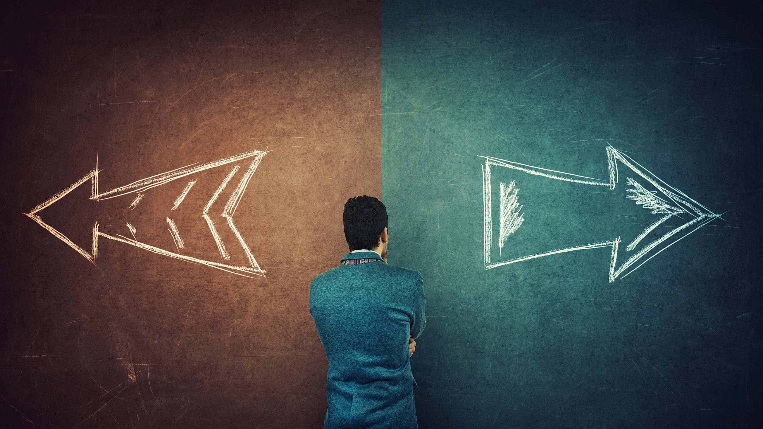 Puzzled Businessman And A Split Blackboard With Arrows Going In